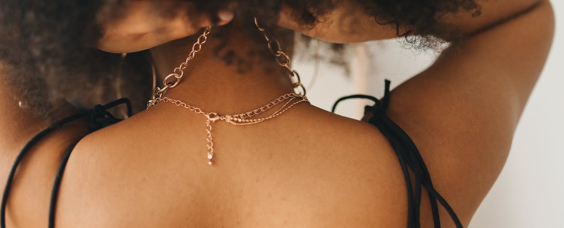 woman wearing gold chain necklace